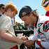Levi Sherwood autographs the shirt of a young fan.