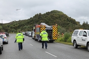The NZCC Rescue Helicopter hovers near the scene of a double fatality on the Taylorville Road, east of Greymouth. The vehicle crashed into a small gully, at right. Photo / Greymouth Star