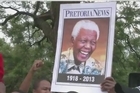 Nelson Mandela's flag-draped casket made a solemn journey through the streets of Pretoria Wednesday, where it will lie in state for three days. Along the route South Africans formed a sombre guard of honour for their iconic leader. 