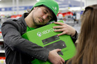 Emanuel Jumatate, from Chicago, hugs his new Xbox One after he purchased it at a Best Buy. Photo / AP