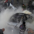 Lebanese citizens extinguish a burned car at the site of a car bomb explosion in a stronghold of the Shiite Hezbollah group at the southern suburb of Beirut, Lebanon. Photo / AP