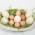 different kinds of eggs arranged over some green leaves in a big bowl