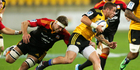 TJ Perenara of the Hurricanes is tackled by Michael Fitzgerald of the Chiefs during the round 15 Super Rugby match between the Hurricanes and the Chiefs. Photo / Getty Images.