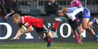 Johnny McNicholl of the Crusaders scores a try in the tackle of Nick Cummins. Photo / Getty Images