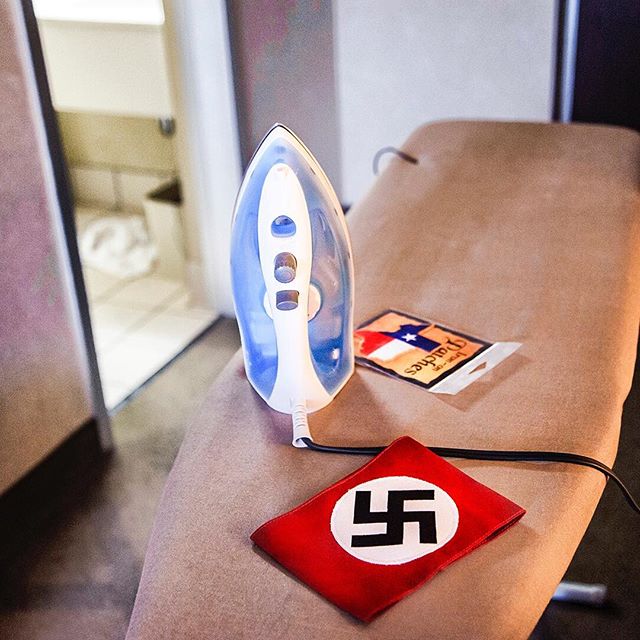 A swastika armband—part of the “battle dress uniform” of the National Socialist Movement—is laid out in preparation for a rally at the Georgia State Capitol on Hitler’s birthday. Last year, in a makeover designed to “mainstream” neo-Nazis, the group dropped the swastika and replaced it with an Odal rune worn by Nazi troops in World War II. In "Hate in the Age of Trump," @vanjones68 and photographer @grief take us inside America's flourishing culture of hate. Read it in our latest issue on stands now, or online at newrepublic.com #hate #kkk #nazi #donaldtrump