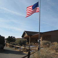 An American flag flies in front of a building