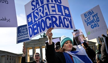 People protest with a sign, reading saving Israeli democracy at a demonstration against Israel's Prime Minister Benjamin Netanyahu who is on a visit in Berlin, Germany, earlier this month.