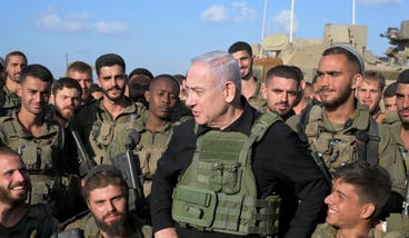 Prime Minister Benjamin Netanyahu speaks to IDF soldiers near the Gaza border, Thursday.