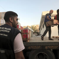Palestinians unload boxes of medicine from a truck arrived at Nasser Medical Complex, as part of the aid batch that entered the Gaza Strip from the Rafah crossing Sunday, in the town of Khan Younis, southern Gaza, Monday, Oct. 23, 2023. (AP Photo/Mohammed Dahman)