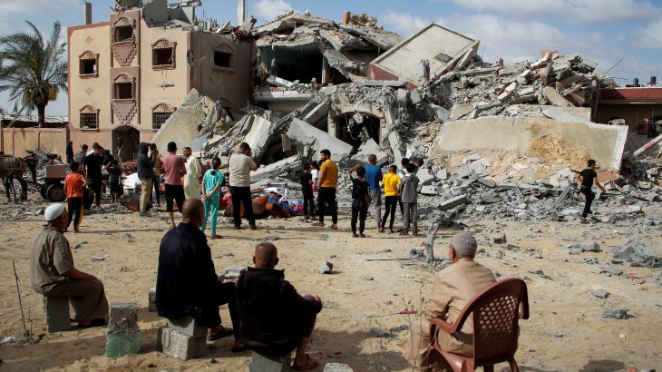 Palestinians look at the site of an Israeli strike on a house, amid the ongoing conflict between Israel and Hamas, in Rafah, in the southern Gaza Strip May 5