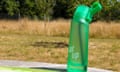 Green Air Up water bottle on picnic table outside surrounded by yellowing grass