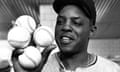 San Francisco Giants outfielder Willie Mays displays the four baseballs in the clubhouse representing the four homers which he hit against the Milwaukee Braves on 30 April 1961.