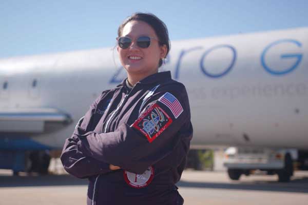 Sheila Xu standing in front of an airplane