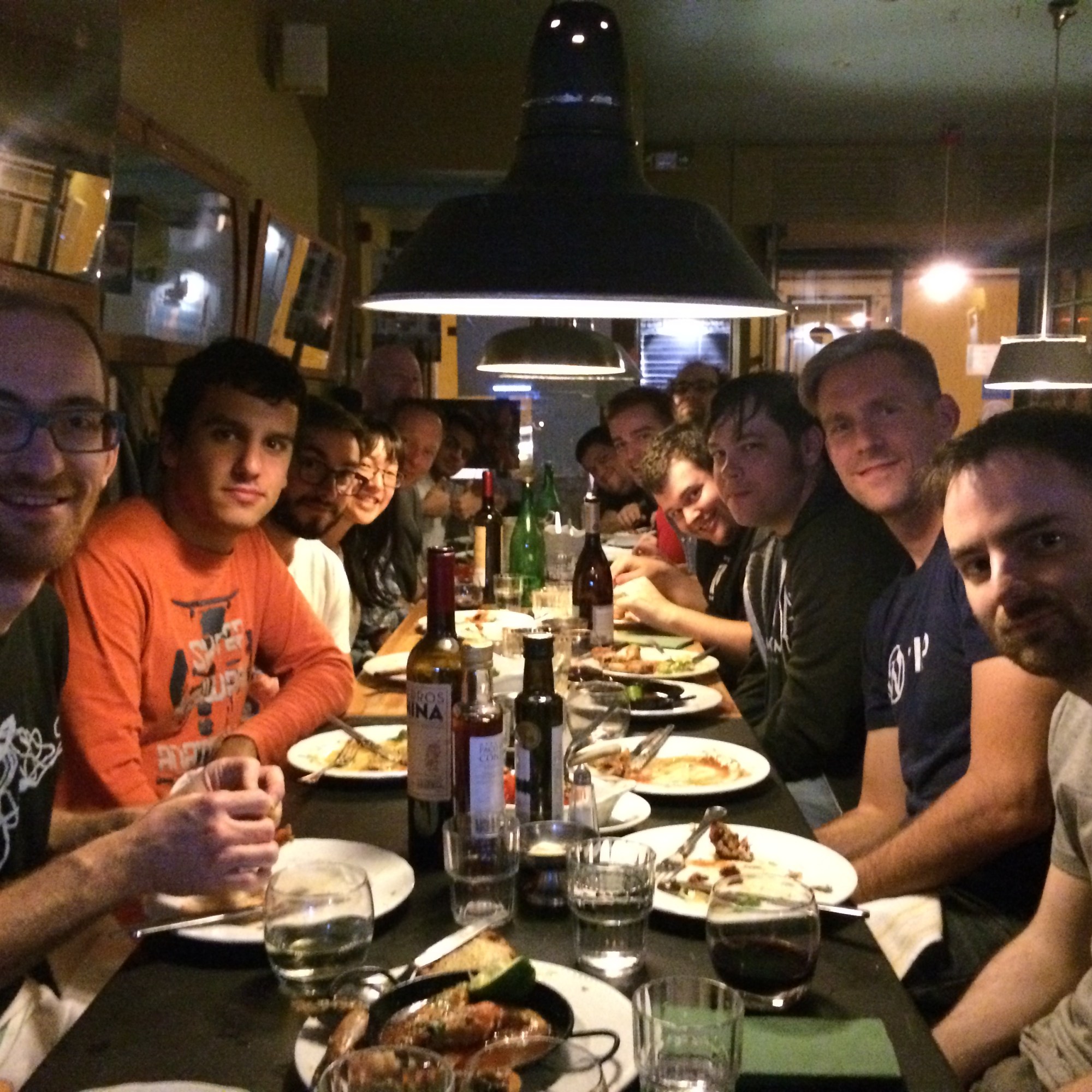 People at a dinner table in a restaurant, on a team meetup in Portugal.