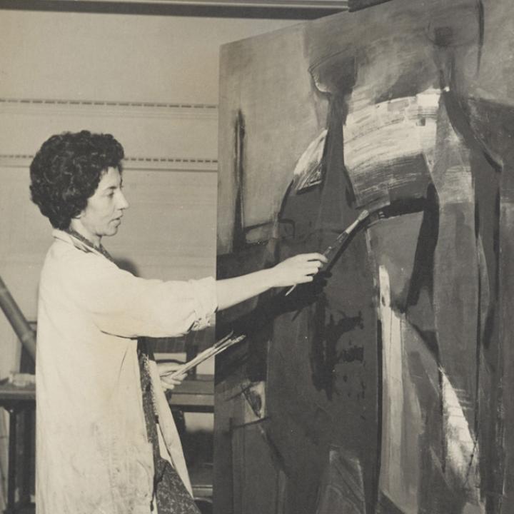 Photograph of María Luisa Pacheco painting in her studio
