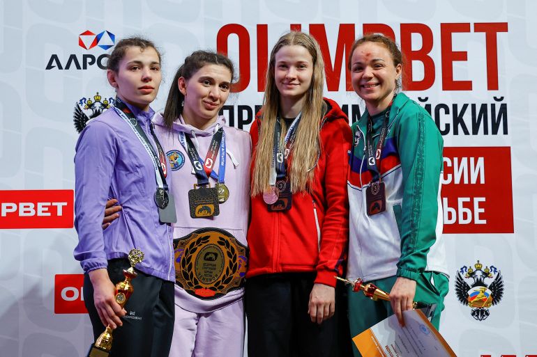 Medal winners Khanum Velieva, Vusala Parfianovich, Elizaveta Petlyakova and Ksenia Burakova take part in an awarding ceremony following the 68kg women's finals at the Russian Pre-Olympic Freestyle Wrestling Championship at Live Arena venue outside Moscow, Russia, May 1, 2024. Russia's top freestyle wrestlers seeking Olympic glory plan to go to Paris this summer but will have to participate as independents and compete without their country's flag or anthem. REUTERS/Evgenia Novozhenina