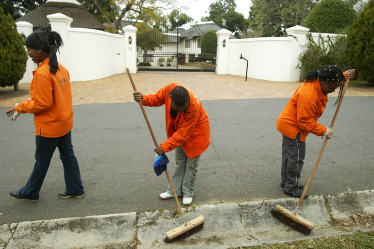 People clean a street in Cape Town