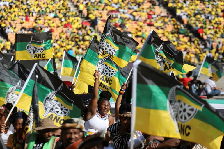 Supporters of the African National Congress (ANC) wave party flags during their final rally ahead of the upcoming election at FNB stadium in Johannesburg, South Africa, May 25, 2024. REUTERS/Alaister Russell