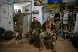 Injured soldiers wait at a medical stabilisation point near the front lines in the Donetsk region [File: Thomas Peter/Reuters]