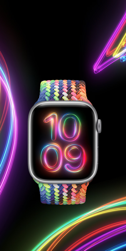 Apple Watch Series 9 s novým pleteným navlékacím řemínkem Pride Edition v neonových barvách a se sladěným ciferníkem Pride Radiance.