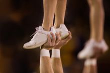 closeup of the shoes of a cheerleader being lifted