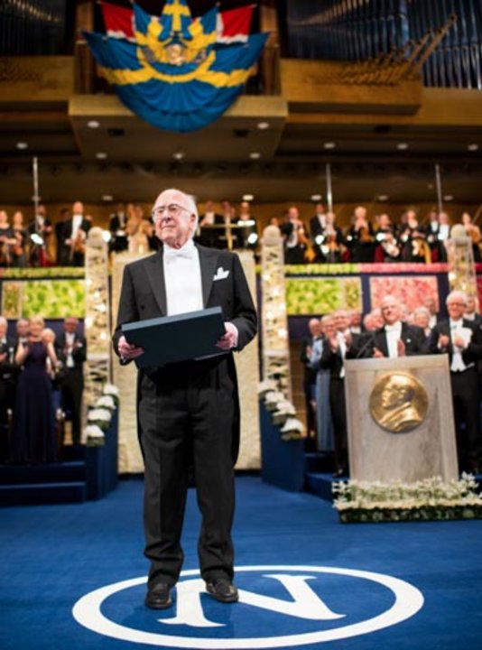 Peter Higgs receiving his Nobel Prize from His Majesty King Carl XVI Gustaf of Sweden