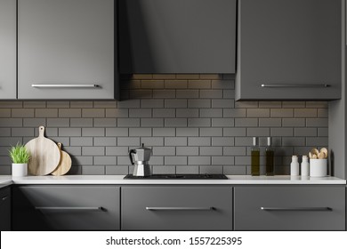 灰色のレンガ壁の現代的なキッチンの内部、調理器を内蔵した灰色のカップ、暗い灰色のカップボード。3Dレンダリングのイラスト素材
