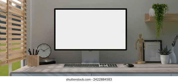 A modern, minimal white home office workspace with a white-screen computer mockup and accessories on a table near by the window. 3d render, 3d illustration Stockillustration