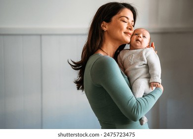 生まれたばかりの赤ん坊を抱きしめて優しい幸せな母親。家族、赤ちゃんの子育てシングルマザーはコンセプトが大好きです。の写真素材