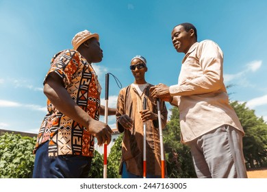 Three blind men are holding a conversation together, friendship between disabled people.: stockfoto