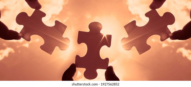 three hands of businessman to connect couple 3 piece with sky background.Jigsaw alone wooden puzzle against sun rays.one part of whole. symbol of association and connection.business strategy. Foto stock