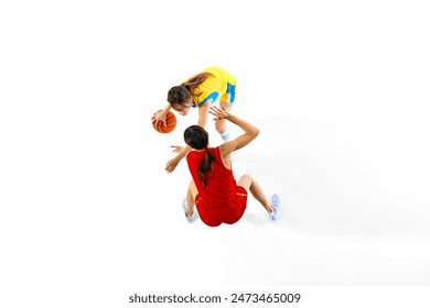 Top view of two women, basketball players in red and yellow uniform playing isolated on white studio background. Concentrated to win. Concept of sport, active lifestyle, competition, game, dynamics Arkistovalokuva