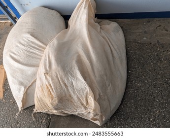 Trinidad and Tobago- July 1, 2024- Sandbags or sand bags placed in front of doors in the event of flooding caused by the passage of Hurricane Beryl. Stock-foto