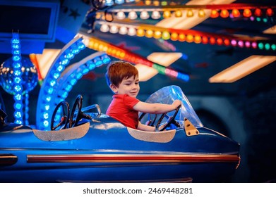 Twilight sets the stage for a young boy's delightful adventure in a blue starry bumper car amidst a kaleidoscope of fair lights Stock-foto
