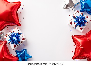 USA Independence Day decorations concept. Top view photo of present boxes with ribbon bows red white blue balloons and star shaped confetti on isolated white background with empty space Stock-foto