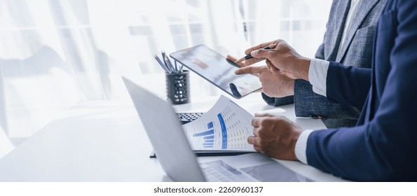 Using tablet pc, Consultant between bookkeepers and accounting lawyer consultation about asset, balance sheet, stock market statistics and yearly tax law, protect business from bribery. Stock-foto