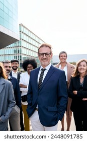 Vertical cheerful smiling team of diverse business people in formal suit looking confident camera with positive faces gathered outside the work building. Happy corporate work team posing for portrait Adlı Stok Fotoğraf