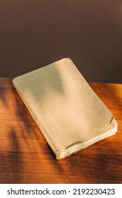 Vintage book cover on table with shadows Stock Photo
