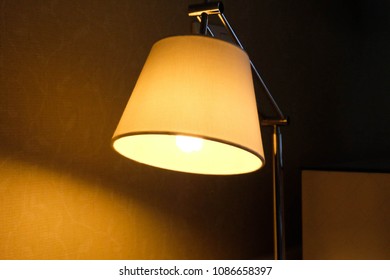Vintage lamp on night table in hotel room.の写真素材