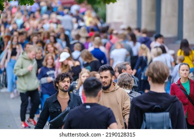Vilnius, Lithuania - June 22, 2022: Crowd of pedestrians moving along urban street in rush hour in city center