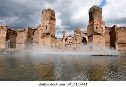 Walls of the Baths of Caracalla in Rome, artificial pool in the foreground inaugurated in 2024 with water features. – Ảnh có sẵn