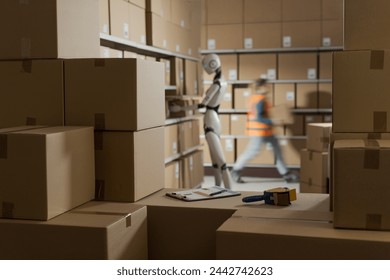 Warehouse worker and AI robot working together, they are picking orders and carrying boxes: automation and logistics concept 库存照片