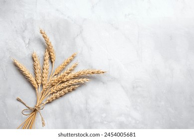 Wheat crops on white marble background, top view, copy space. Happy Shavuot. Jewish holiday shavuot concept template.