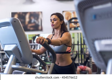 Woman exercising at the gym in an elliptical trainer Cardio training Foto Stock