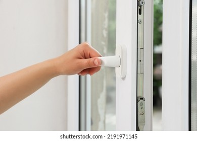 Woman opening white plastic window at home, closeup Arkistovalokuva