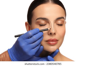 白い背景に美容整形手術の準備をする女性。医師が彼女の顔に印を描いた、接写の写真素材