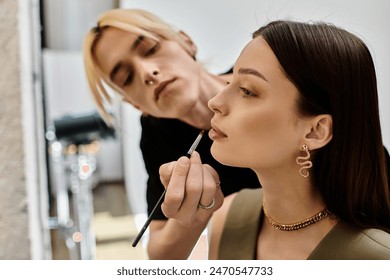 A woman receives a professional makeup application from another woman. – Ảnh có sẵn