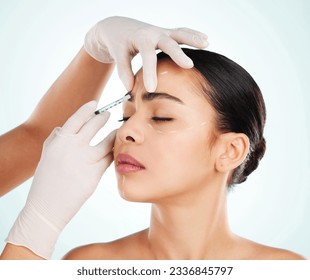 Woman, skincare and face injection for plastic surgery in studio isolated on white background. Facial, syringe and cosmetics of female model with collagen filler for dermatology, beauty or aesthetic. Stockfotó