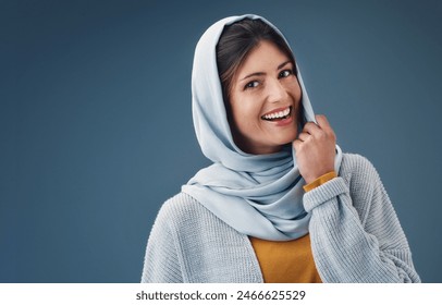 Woman, studio and smile with hijab in portrait with happy for confidence for islamic culture. Faith, beauty and pride with blue background for arab people with religion, middle east and natural: stockfoto
