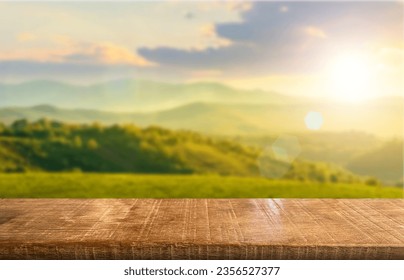 Wooden table top on blur mountain and grass field.Fresh and Relax concept.For montage product display or design key visual layout.View of copy space. ภาพถ่ายสต็อก